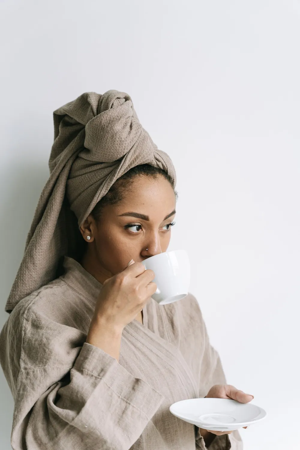 A woman in a robe enjoying morning coffee